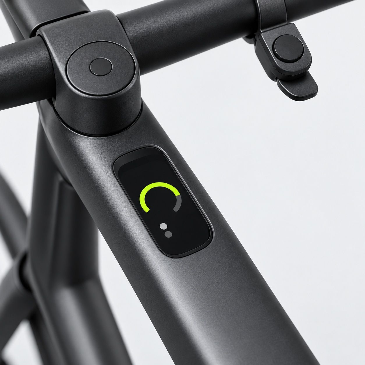 Macro of a graphite e-bike top tube display showing a lime arc gauge